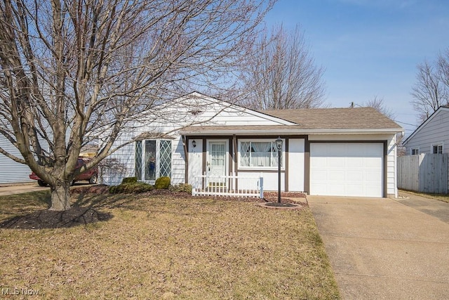 view of front of home with driveway, a front lawn, a porch, fence, and an attached garage