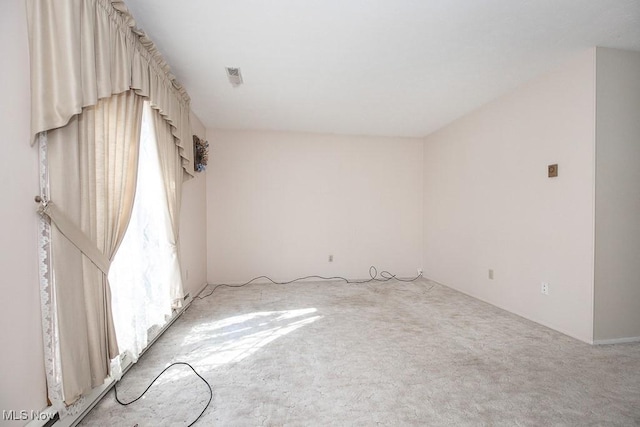 unfurnished room with light colored carpet