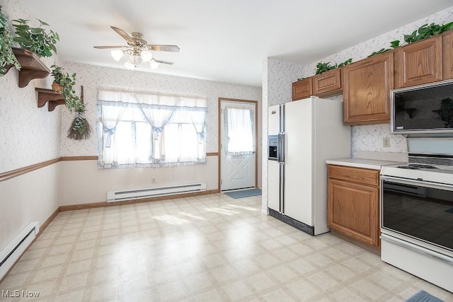 kitchen featuring wallpapered walls, white appliances, light floors, and baseboard heating