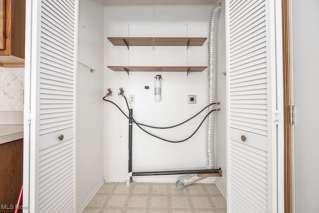 laundry room featuring baseboards, light floors, laundry area, hookup for a washing machine, and hookup for an electric dryer