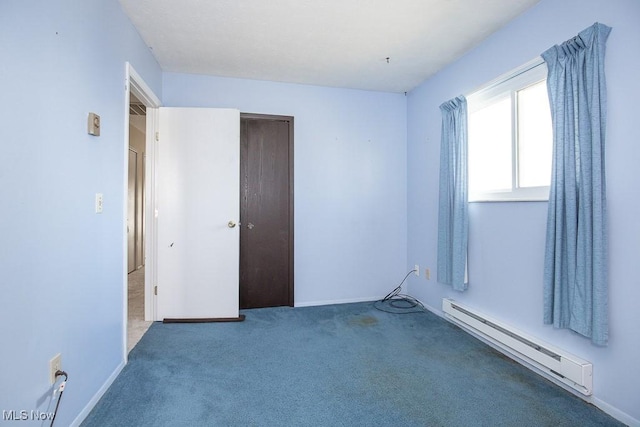 carpeted empty room with baseboards and a baseboard radiator