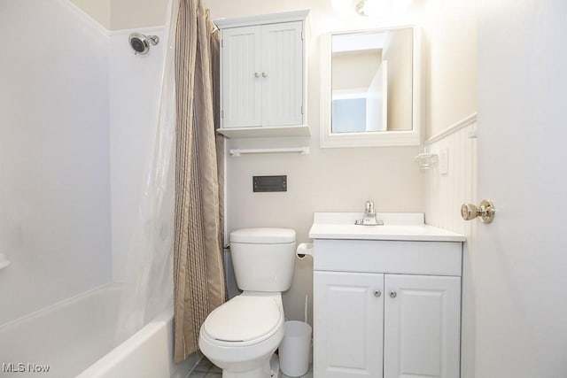 bathroom featuring shower / bath combo with shower curtain, toilet, and vanity