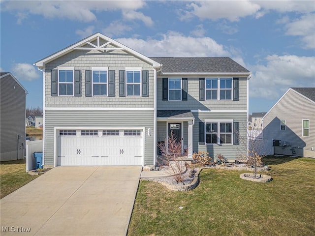 craftsman-style home with an attached garage, concrete driveway, a front yard, and fence