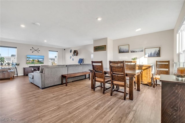 dining area with recessed lighting, plenty of natural light, and wood finished floors