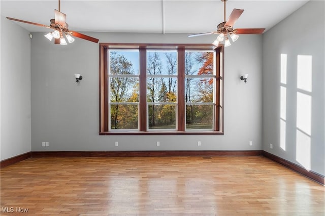 unfurnished room with ceiling fan, baseboards, and light wood-style flooring