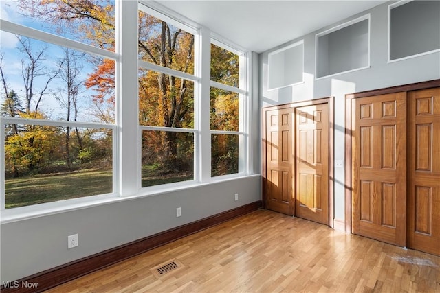 unfurnished sunroom with visible vents