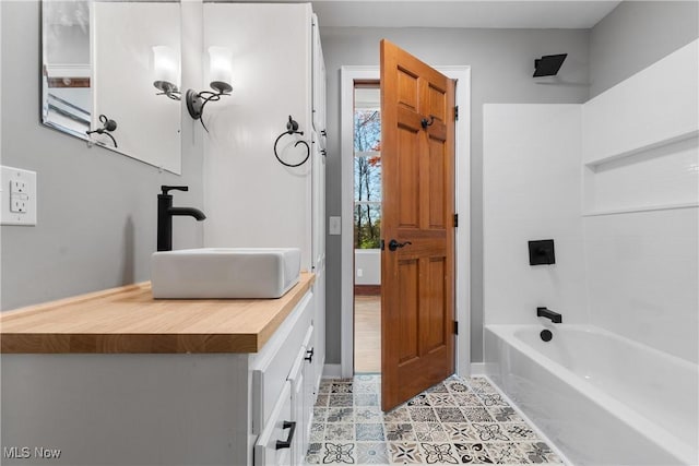 bathroom featuring vanity, tile patterned floors, and tub / shower combination