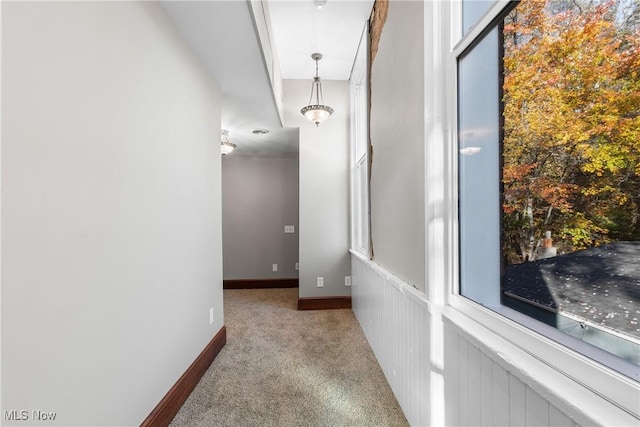 hall with carpet flooring and baseboards