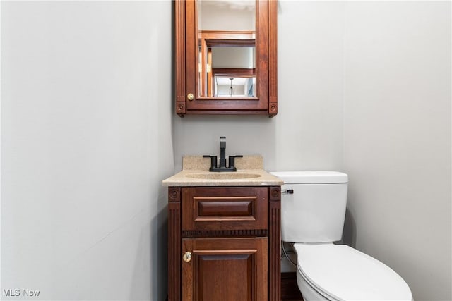 bathroom featuring toilet and vanity