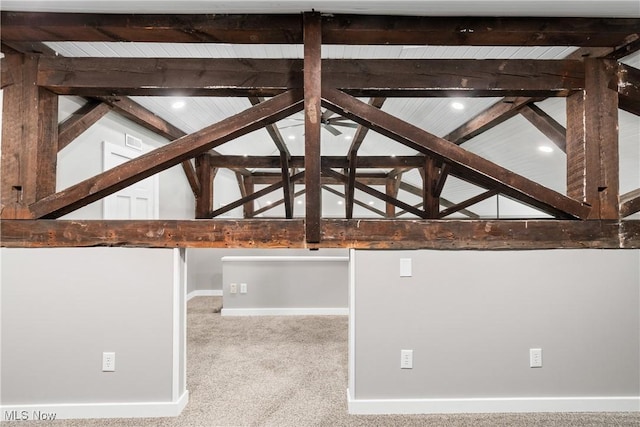 interior space featuring beam ceiling, carpet, and baseboards