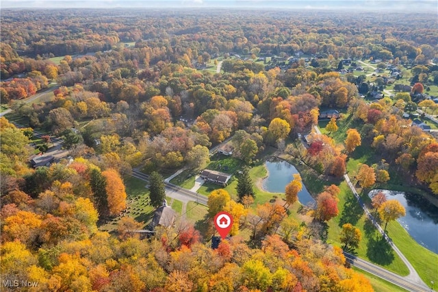 aerial view featuring a forest view and a water view