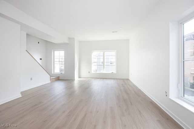 spare room with light wood-type flooring and baseboards