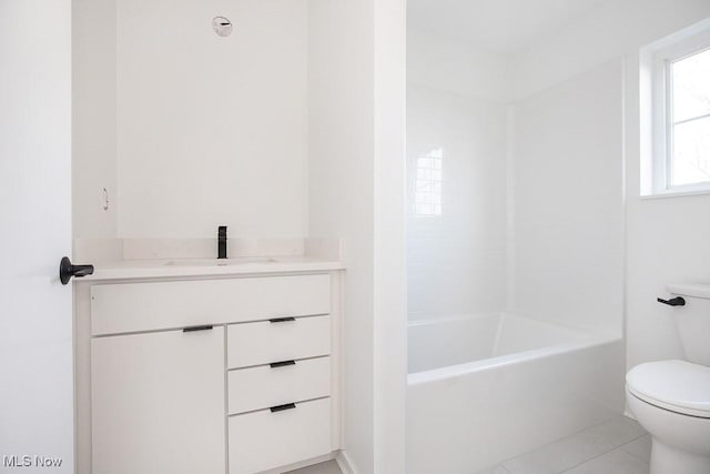 bathroom featuring tile patterned flooring, toilet, and vanity