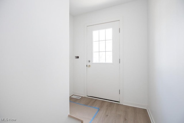 entryway with visible vents, light wood-type flooring, and baseboards