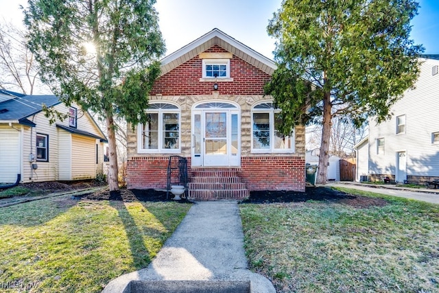 view of front of home featuring stone siding, brick siding, and a front lawn