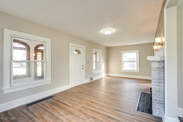 entrance foyer with visible vents, baseboards, and wood finished floors