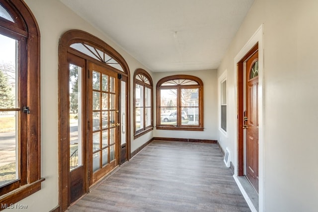 unfurnished sunroom with visible vents