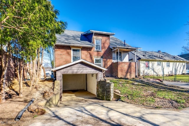 view of front of house with brick siding and concrete driveway