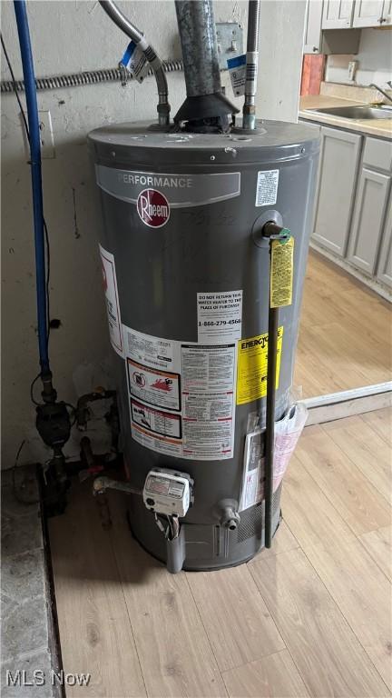 utilities with gas water heater and a sink