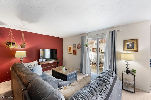 living room with baseboards, light carpet, and a textured ceiling