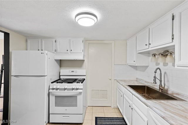 kitchen featuring under cabinet range hood, white appliances, white cabinetry, and a sink