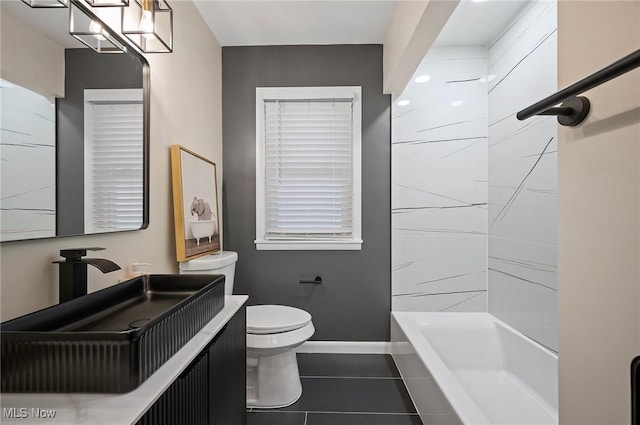 full bath featuring tile patterned floors, toilet, baseboards, bathing tub / shower combination, and vanity