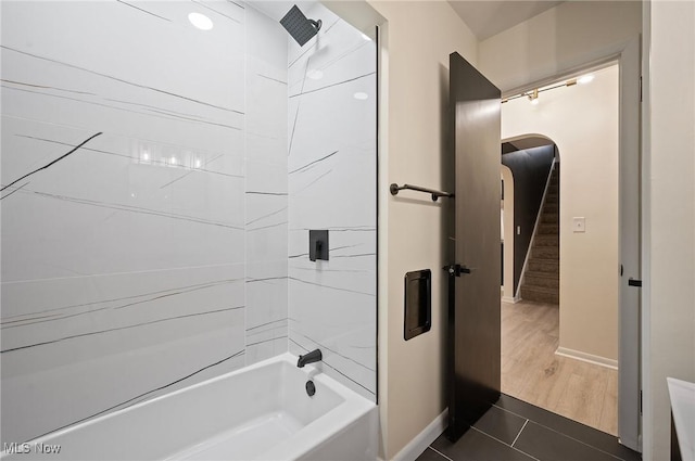 full bathroom featuring tile patterned floors, baseboards, and shower / washtub combination