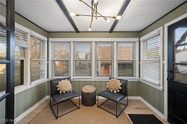 sunroom / solarium with a notable chandelier