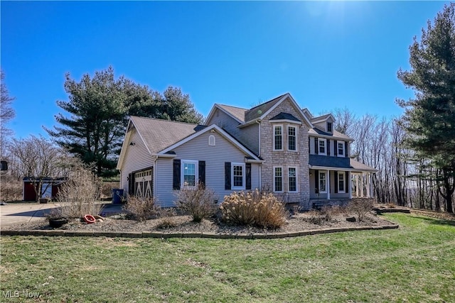 exterior space with stone siding, a lawn, and an attached garage