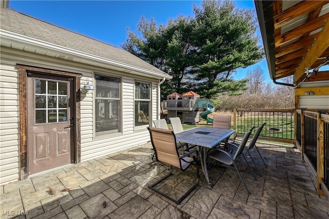 view of patio featuring outdoor dining space and a playground