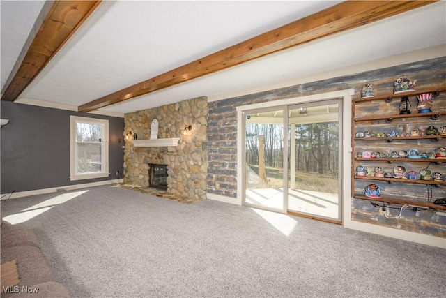 unfurnished living room featuring beam ceiling, carpet floors, and a fireplace