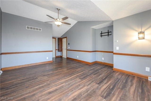 unfurnished room with visible vents, a ceiling fan, wood finished floors, baseboards, and lofted ceiling