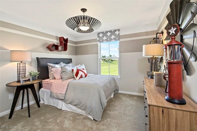 carpeted bedroom featuring baseboards