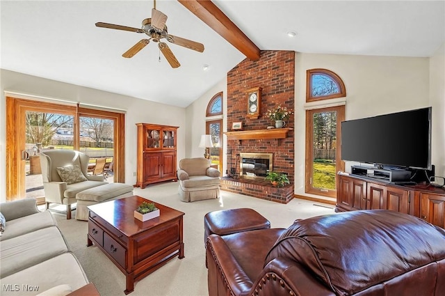 living room with a fireplace, vaulted ceiling with beams, light colored carpet, and ceiling fan