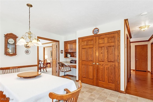 dining space featuring baseboards and an inviting chandelier