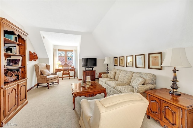 living area featuring vaulted ceiling and light carpet