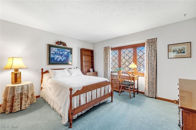 bedroom featuring baseboards, a textured ceiling, and carpet