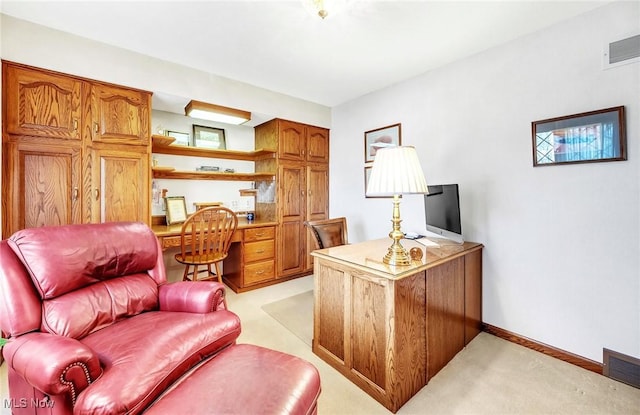 home office featuring baseboards, visible vents, and light carpet