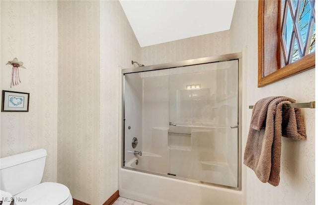 bathroom with toilet, wallpapered walls, baseboards, and bath / shower combo with glass door