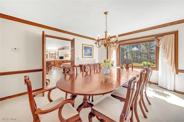 dining area featuring a chandelier, light colored carpet, crown molding, and baseboards