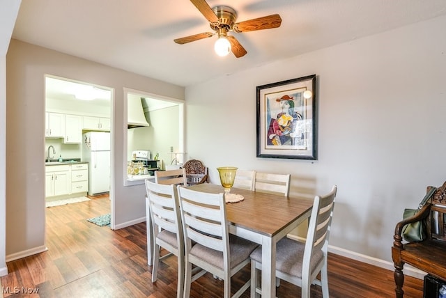 dining space with ceiling fan, baseboards, and wood finished floors