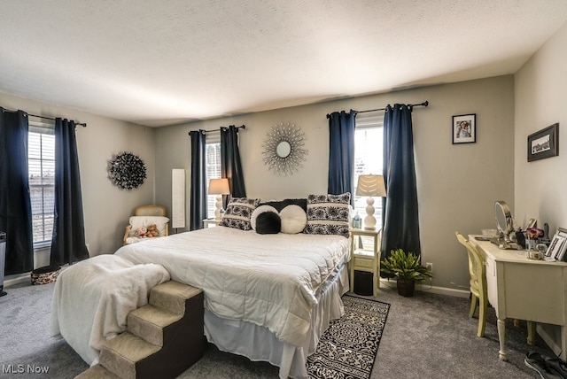 bedroom featuring a textured ceiling, baseboards, and carpet floors