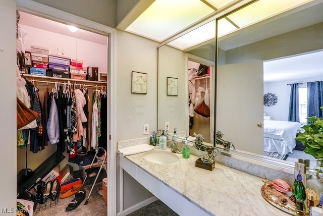 full bathroom featuring ensuite bath and vanity