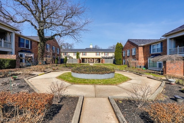 view of community featuring fence and a residential view