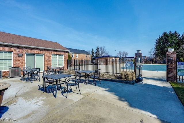 view of patio featuring cooling unit and fence