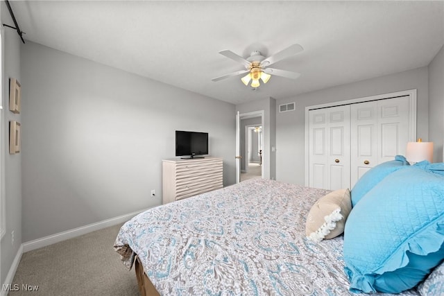 bedroom with visible vents, baseboards, carpet flooring, a closet, and a ceiling fan