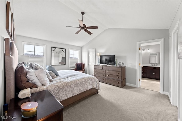 bedroom with connected bathroom, baseboards, light colored carpet, ceiling fan, and vaulted ceiling