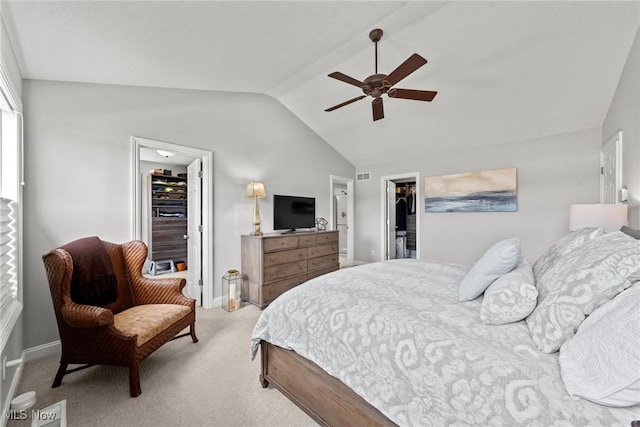 bedroom featuring visible vents, vaulted ceiling, a spacious closet, a closet, and light colored carpet