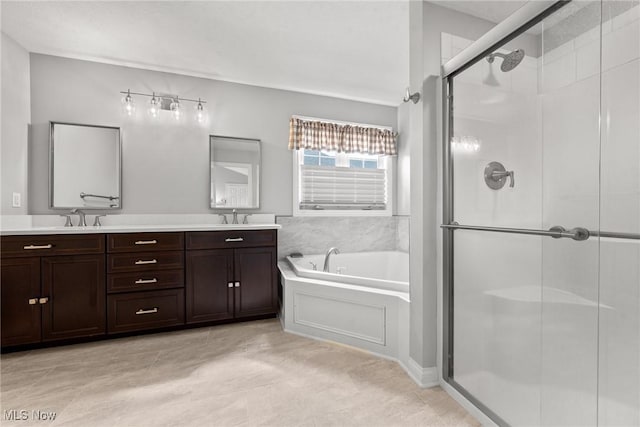 bathroom featuring a bath, a shower stall, double vanity, and a sink