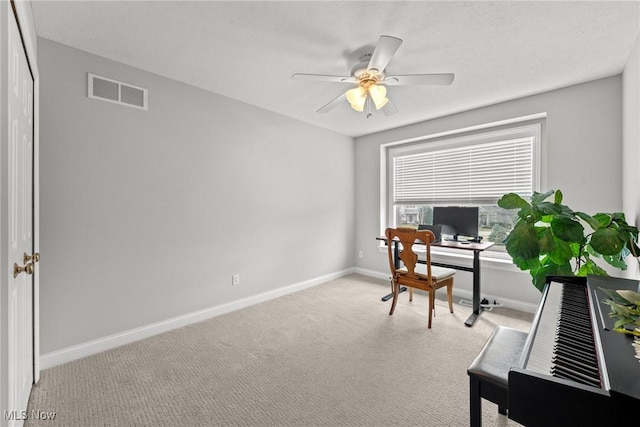 office featuring baseboards, carpet, visible vents, and ceiling fan